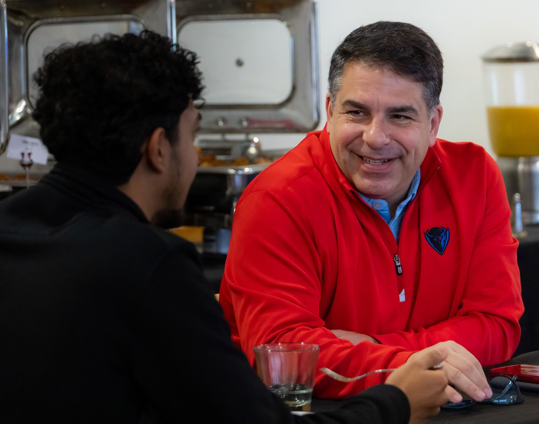 DePaul President Rob Manuel talks with a student about thier experience. (Photo by Jeff Carrion / DePaul University) 